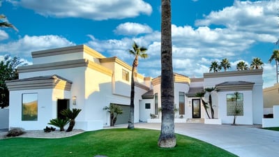 Modern white fa ade accented with desert greenery and bold rooflines. A perfect fusion of clean design and timeless elegance.