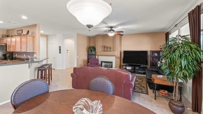 A beautiful dining area opens effortlessly to the living room and kitchen. Elegant lighting and tile floors enhance its bright, open ambiance.