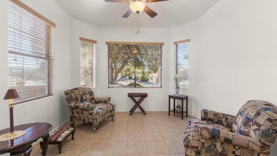 Relax in this cheerful breakfast nook surrounded by windows and natural light. A comfortable, airy space ideal for casual dining or reading.