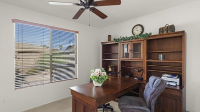 This dedicated office space offers natural light, built-in shelving, and quiet ambiance perfect for working from home in comfort and style.