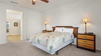 This bright and spacious primary suite combines comfort and function, with direct access to the ensuite bath and generous natural lighting.