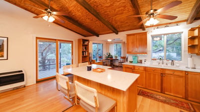 This spacious deck offers the perfect setting for open-air dining and quiet evenings surrounded by mountain views. With multiple seating options and a peaceful desert backdrop, it enhances the home s inviting Hackberry lifestyle.