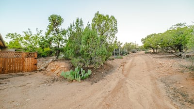 The natural dirt road winds through native vegetation, offering a secluded entrance to the property. A perfect introduction to the quiet, expansive lifestyle Hackberry provides.
