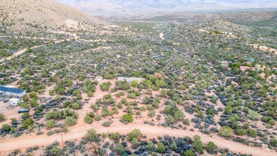 From above, the layered hills and desert shrubs frame the property beautifully, highlighting its peaceful placement within Hackberry s natural landscape. A true retreat for nature lovers