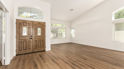 Bright Scottsdale living room with vaulted ceilings, wide windows, and modern flooring that enhances the open layout. Natural light fills the space, creating an inviting atmosphere perfect for everyday living.