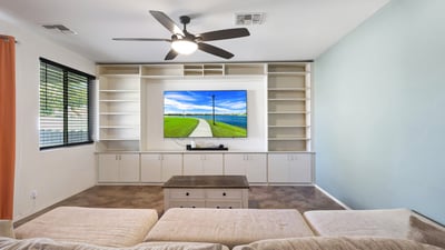 Open great room with tile floors and ceiling fan, seamlessly connecting the main living areas for comfortable daily living.