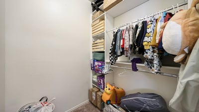 Walk-in closet offering generous space for clothing and storage, enhancing bedroom versatility.