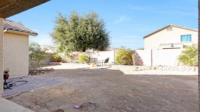 Sliding door view highlighting the expansive backyard and natural light, enhancing the home s open and airy feel.