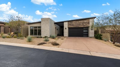Contemporary Scottsdale exterior showcasing refined materials, clean lines, and desert-inspired landscaping. A striking example of modern luxury design in a gated community.