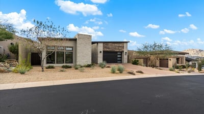 Modern home exterior with minimalist architecture and low-maintenance desert landscaping. Designed for buyers seeking upscale Scottsdale living with strong curb appeal.