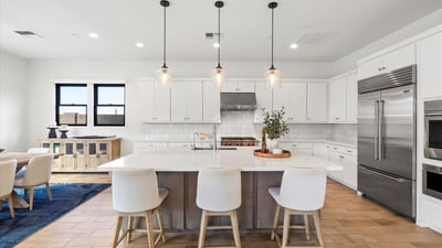 Oversized island offering seating, prep space, and storage, all wrapped in sleek modern design. A central gathering point in this Scottsdale gourmet kitchen.