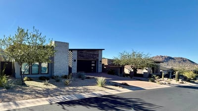 Front-of-home view emphasizing the home s refined architecture, stone finishes, and low-maintenance landscaping in North Scottsdale.