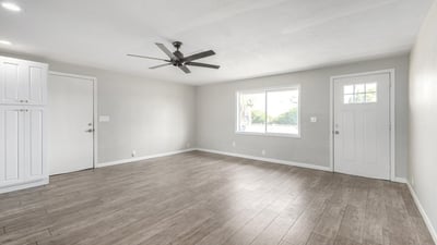 Front living area with natural light and modern finishes ideal for a reading nook, home office, or extra seating space in this Phoenix property with an open layout.