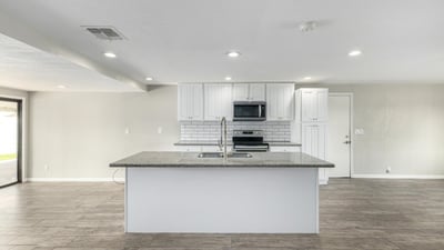 Seamless kitchen-to-dining layout with a spacious granite island and bright open design built for entertaining and everyday convenience in this Phoenix home.