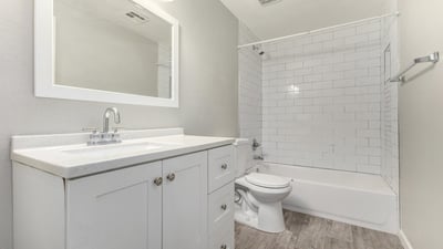 Updated full bathroom with modern vanity, large framed mirror, and subway tile shower surround clean, stylish, and ready for everyday living in Phoenix.
