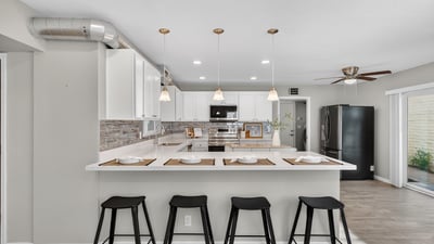 Large kitchen island with seating and pendant lighting, offering the perfect gathering space for hosting and daily use.