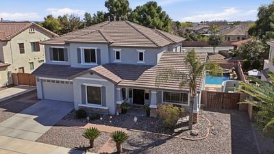 Drone perspective highlighting the beautiful Queen Creek home with a private pool and spa backyard, desert landscaping, and spacious lot within the desirable Cortina neighborhood.