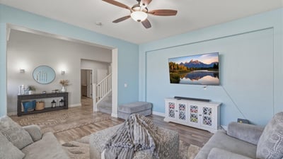 View from the living room toward the open entryway, showcasing the spacious layout, tall ceilings, and modern finishes throughout the home.