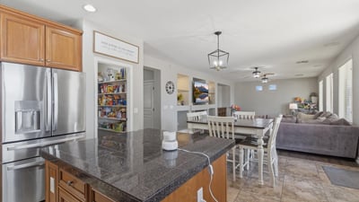 Functional kitchen featuring granite countertops, stainless steel appliances, and center island with seating, perfect for meal prep and casual dining.