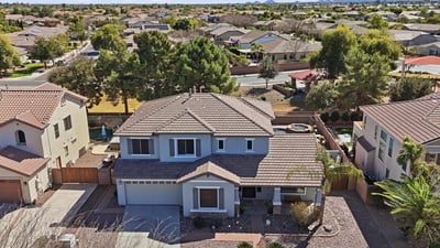 Aerial photo highlighting the full property footprint, landscaped yard, and surrounding neighborhood streets in this desirable Queen Creek location.