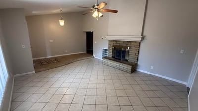 Spacious interior living and dining area with tile flooring and vaulted ceilings. The bright layout enhances the flow and livability of this Glendale home.