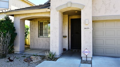 Private covered entry with elegant architectural features and shaded porch. Enhances curb appeal and welcomes guests to this Phoenix property.