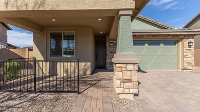 Charming front porch with architectural columns and shaded entry, creating an inviting first impression for this upgraded Peoria residence.