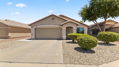 Elevated view of this well-kept property highlighting its clean exterior, garage, and peaceful residential setting in Surprise.