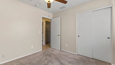 Inviting bedroom with neutral finishes, ceiling fan, and natural light ready for personalization.