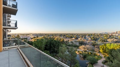 Elevated balcony overlooking landscaped park areas and walking paths, creating a peaceful outdoor space in Phoenix.
