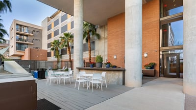 Outdoor patio with dining tables and grilling station, providing a functional space for gatherings in Phoenix.