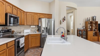 Kitchen featuring stainless steel appliances, spacious counters, and efficient layout, enhancing everyday living in this Phoenix property.