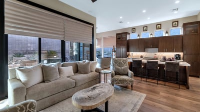 Flowing layout connecting living, dining, and kitchen spaces with abundant natural light ideal for entertaining in this Phoenix property.