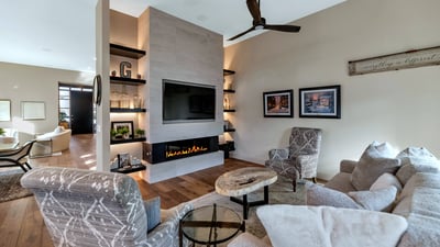 Contemporary fireplace wall with built-ins and warm finishes, adding both style and function to this Phoenix home s main living area.