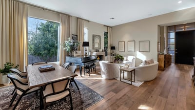 Flowing layout connecting dining and living spaces with modern finishes and warm wood flooring in this Phoenix property.