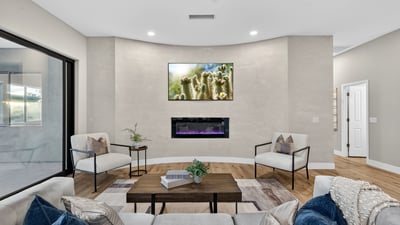Contemporary Scottsdale living room showcasing a sleek fireplace, neutral tones, and updated finishes, creating a comfortable and stylish gathering space.