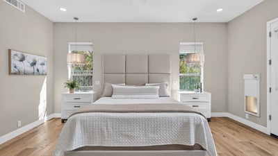 Stylish Scottsdale bedroom with abundant natural light, updated lighting fixtures, and neutral finishes for a calm, contemporary feel.