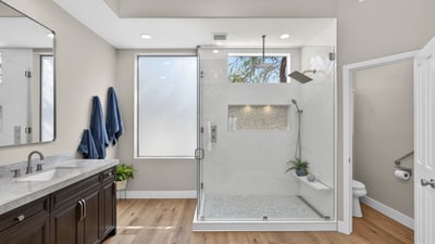 Upgraded Scottsdale bathroom showcasing a glass-enclosed shower, custom tile accents, and modern fixtures.