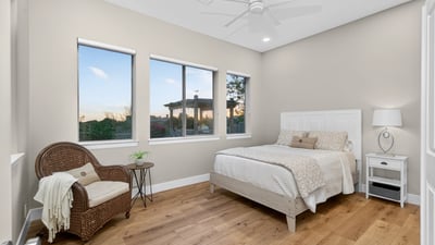 Scottsdale bedroom with multiple windows, wood flooring, and abundant natural light, creating an open and airy feel.