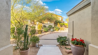 Scottsdale entry path with desert plants, stone accents, and low-maintenance landscaping leading to the front entrance.