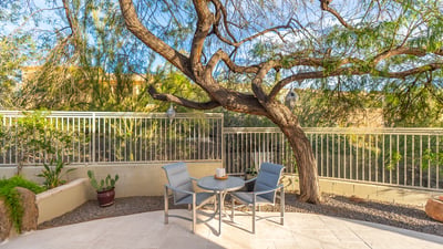 Peaceful Scottsdale garden area with patio seating, mature trees, and desert landscaping for a private outdoor retreat.