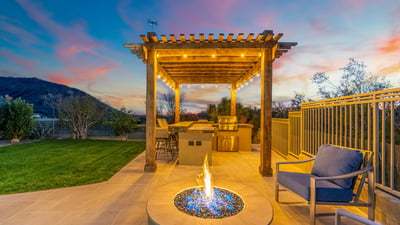 Scottsdale patio with fire pit, pergola, and outdoor kitchen area, offering a cozy and stylish entertaining space.