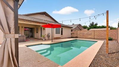 Backyard retreat with pool, patio, and easy-care landscaping. Ideal for relaxing or entertaining in this Casa Grande home.