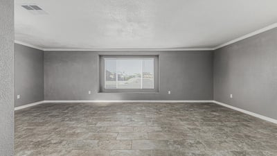 Light-filled living room with updated flooring and large window. This Sun City home offers a clean, modern feel with move-in ready convenience.