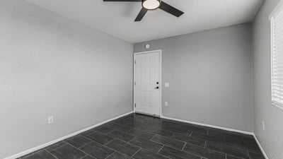 Flexible interior space with tile flooring and ceiling fan. This Sun City home provides options for office, guest room, or hobby area.