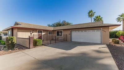 Wide driveway with attached two-car garage and private patio entry. This Sun City home combines convenience, functionality, and well-maintained exterior features.