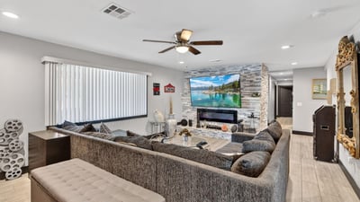 Updated living space with sleek fireplace, neutral palette, and modern finishes, offering comfort and style in this Phoenix home.