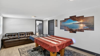 Comfortable lounge area paired with game space, showcasing the flexibility and livability of this remodeled Phoenix property.