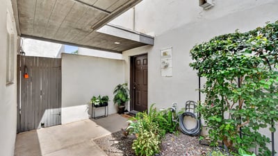 Private Scottsdale covered entry with desert landscaping and shaded design, creating a welcoming and low-maintenance entrance to the home.