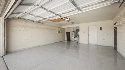 Offering extensive shelving, durable flooring, and generous parking capacity, this garage is designed for organization and convenience. The spacious layout accommodates vehicles, tools, and seasonal storage with ease.